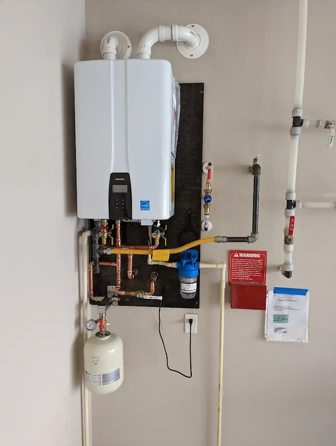 Professional plumber installing copper piping in a Chantilly home